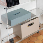 Storage boxes on a metal shelf with hexagonal tiles on the floor