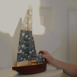 Child playing with Nofred Burgundy Toy Sailing Boat