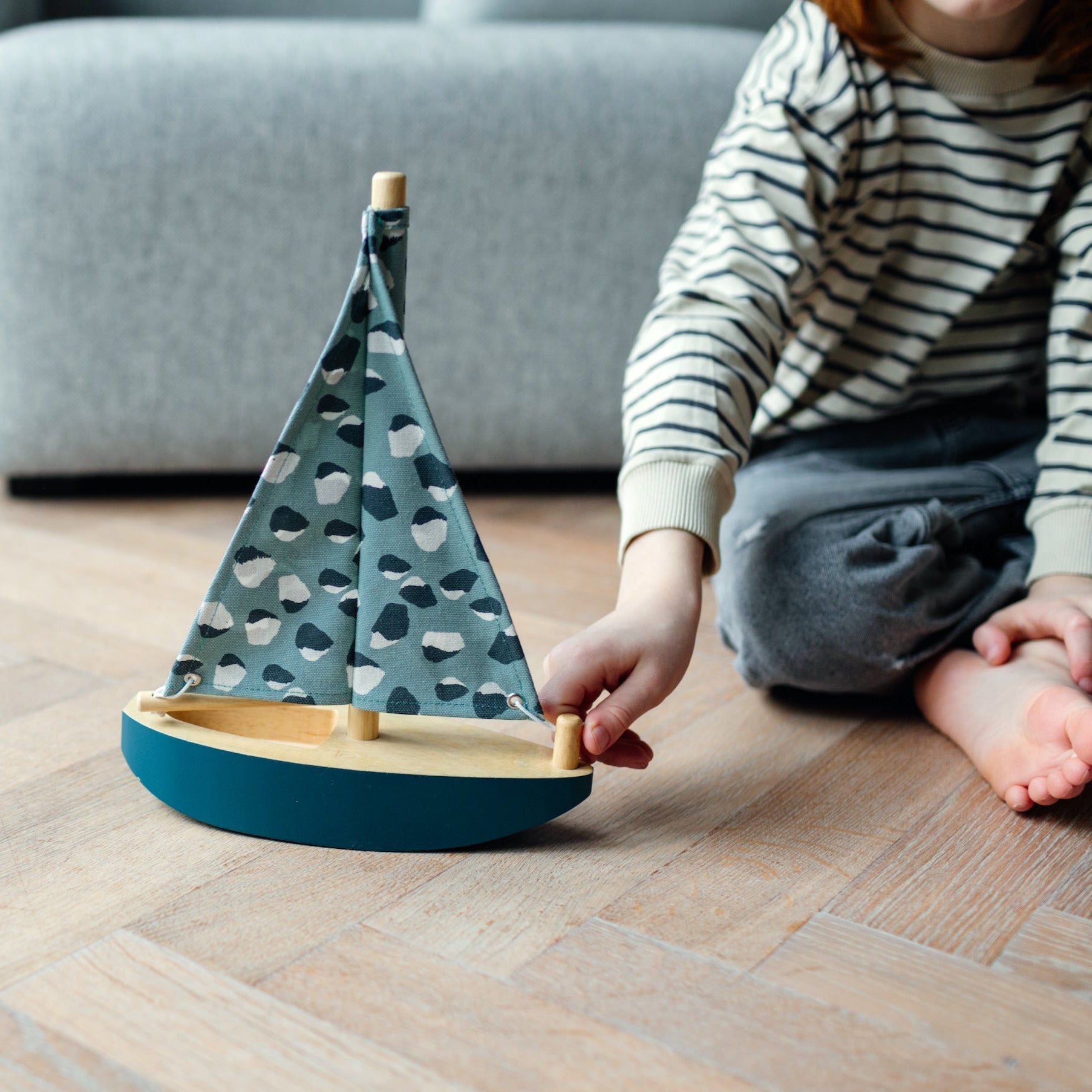 Child plays with Nofred Petroleum Toy Sailing Boat 