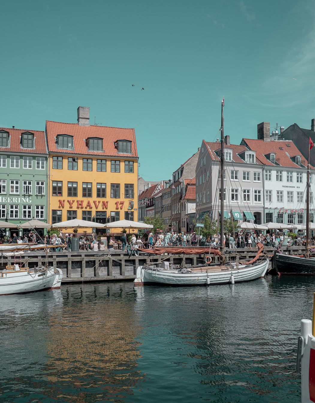 Harbor scene with colorful buildings and boats in Nyhavn, Copenhagen.