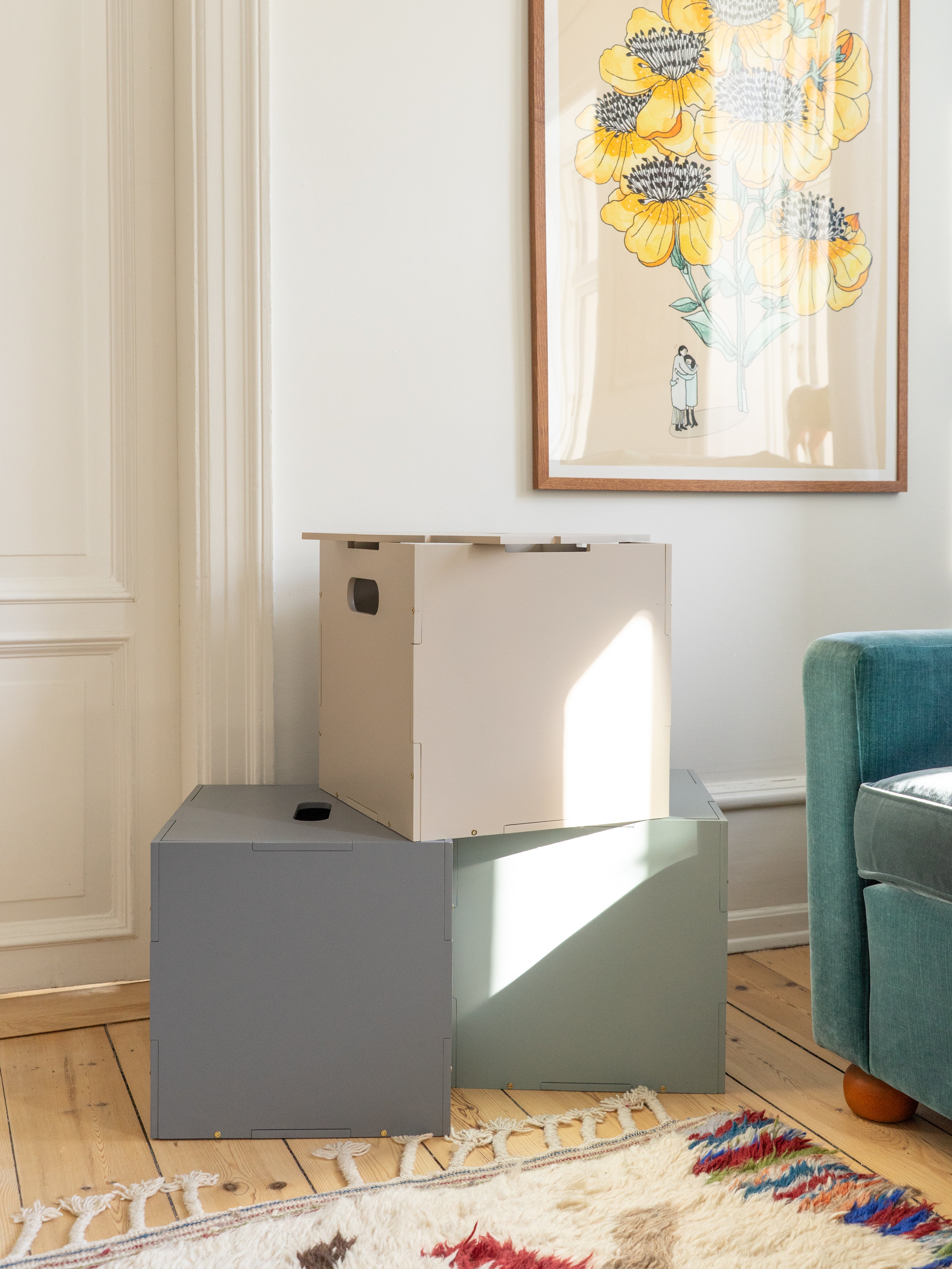 Modern side table with a box on top in a living room setting.