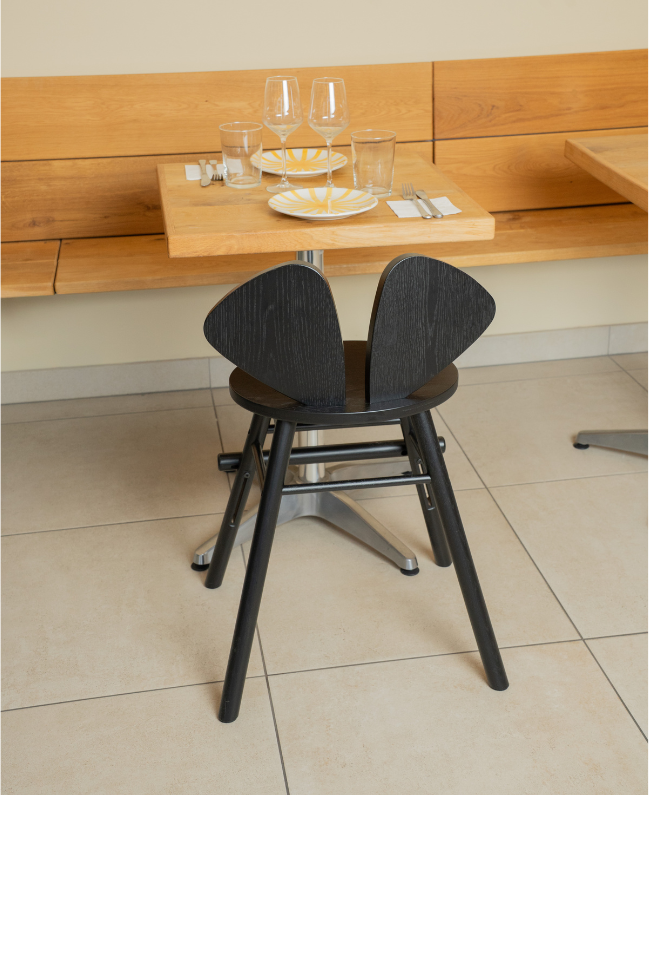 chair in a dining setting with a neutral background.