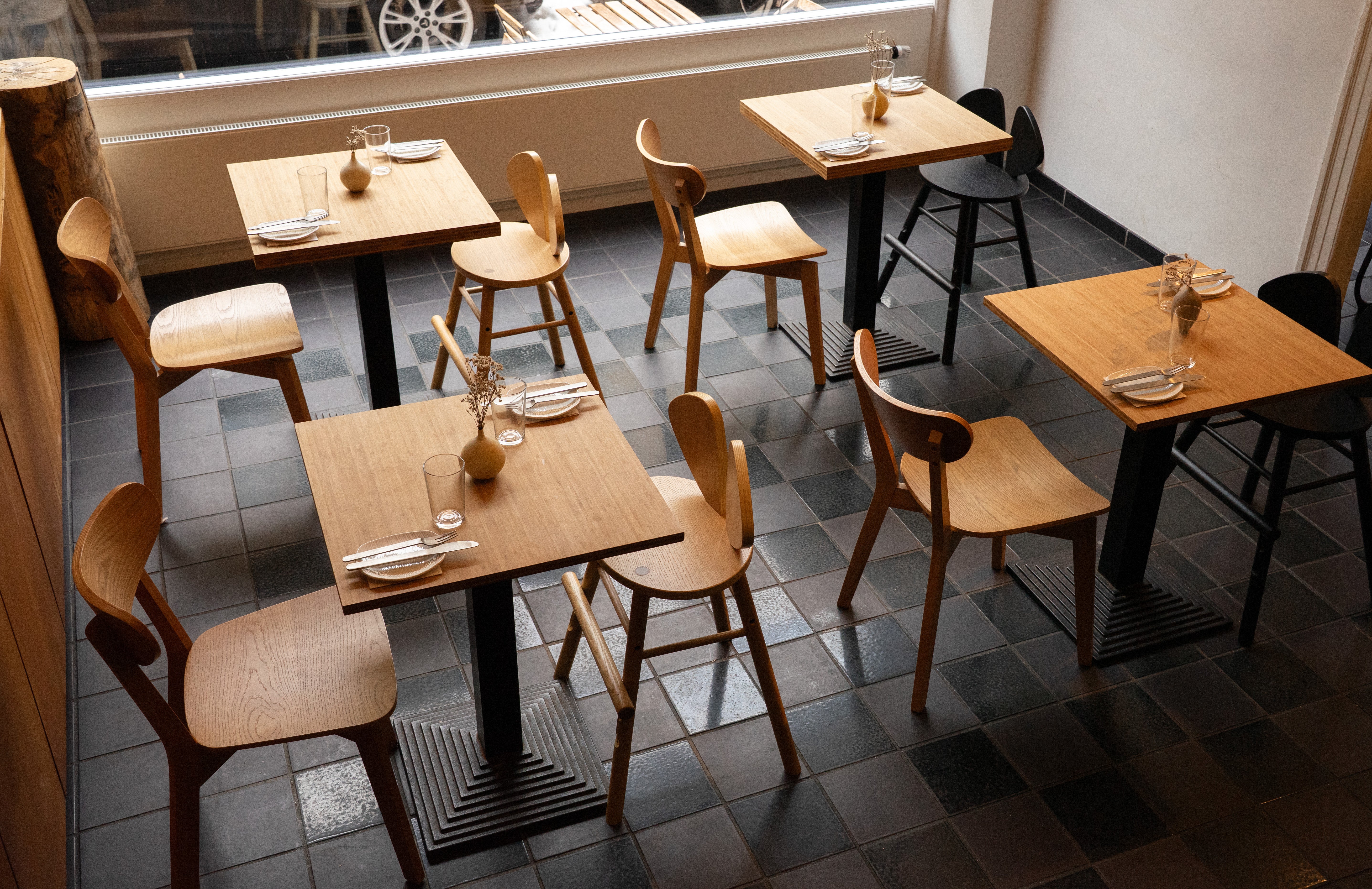 Dining area with wooden tables and chairs in a restaurant setting.