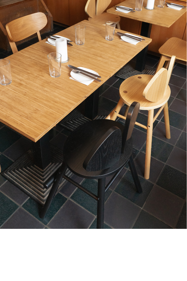 A restaurant interior with wooden tables and chairs.