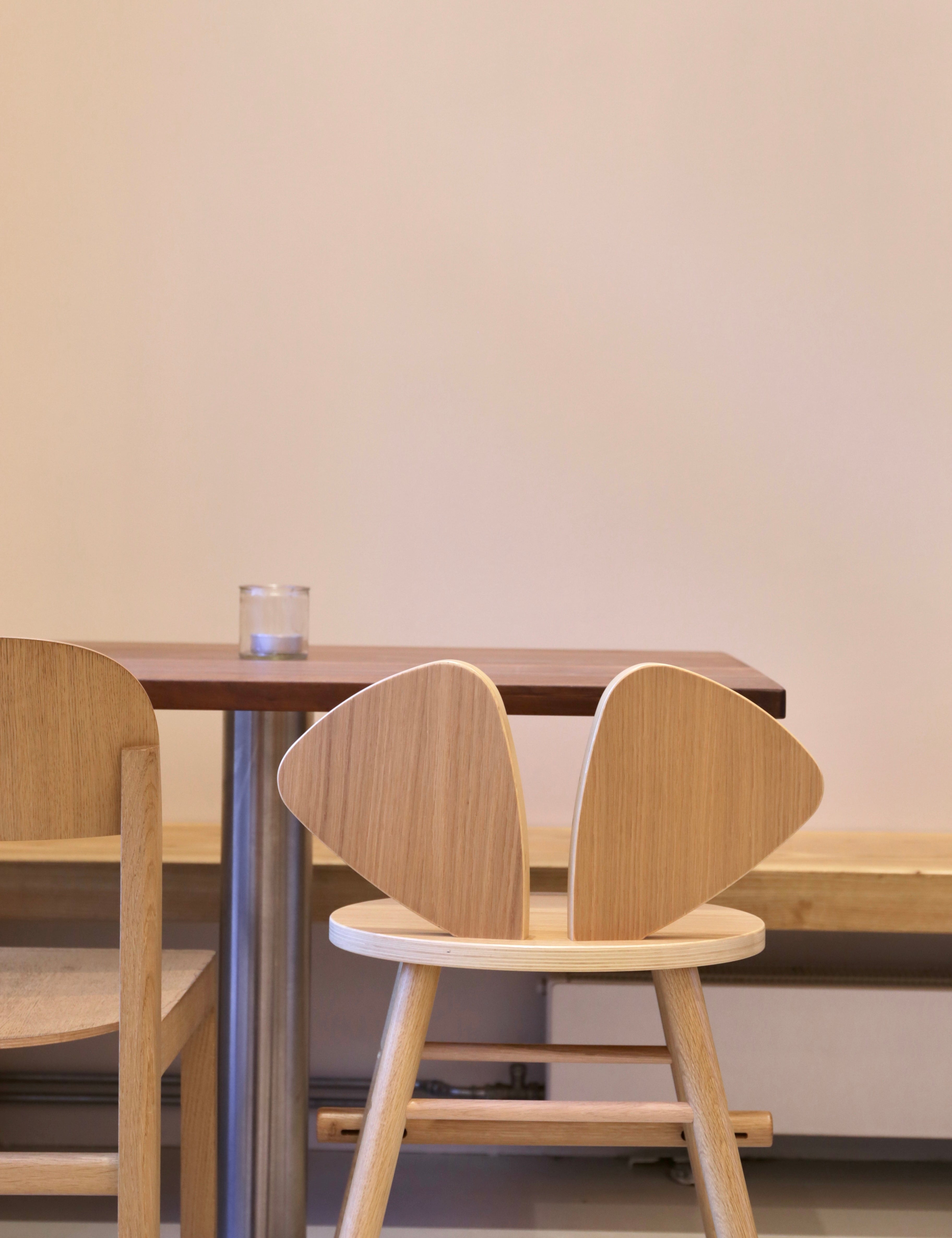 Wooden chair with unique backrest design in a minimalistic setting