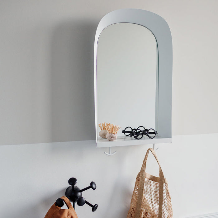 Childrens white wall mirror in the family hallway