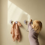 Girl hanging toys on Nofred Lilac Stars & Moons Kids Hooks