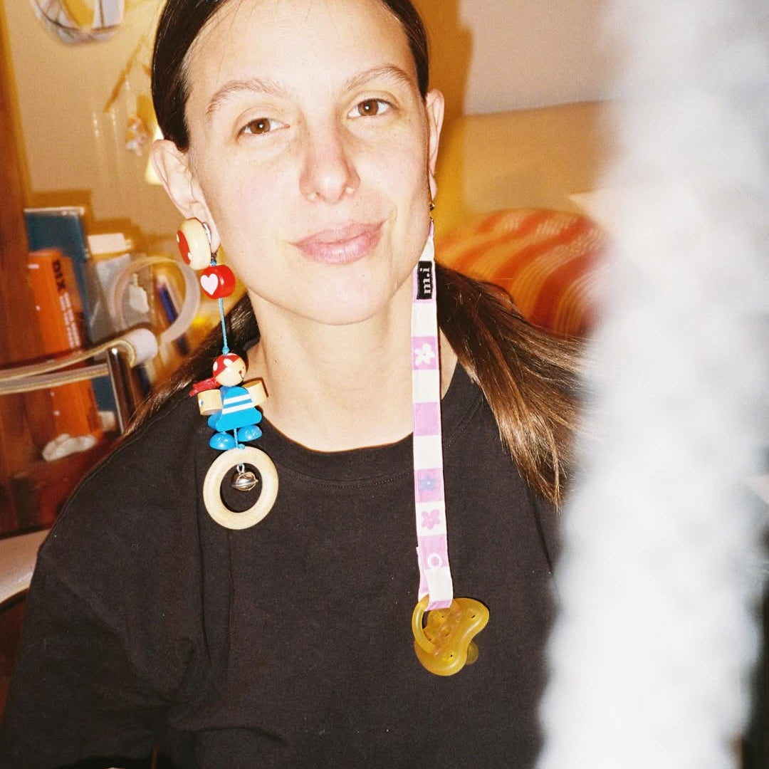 Person wearing colorful necklaces in a casual setting