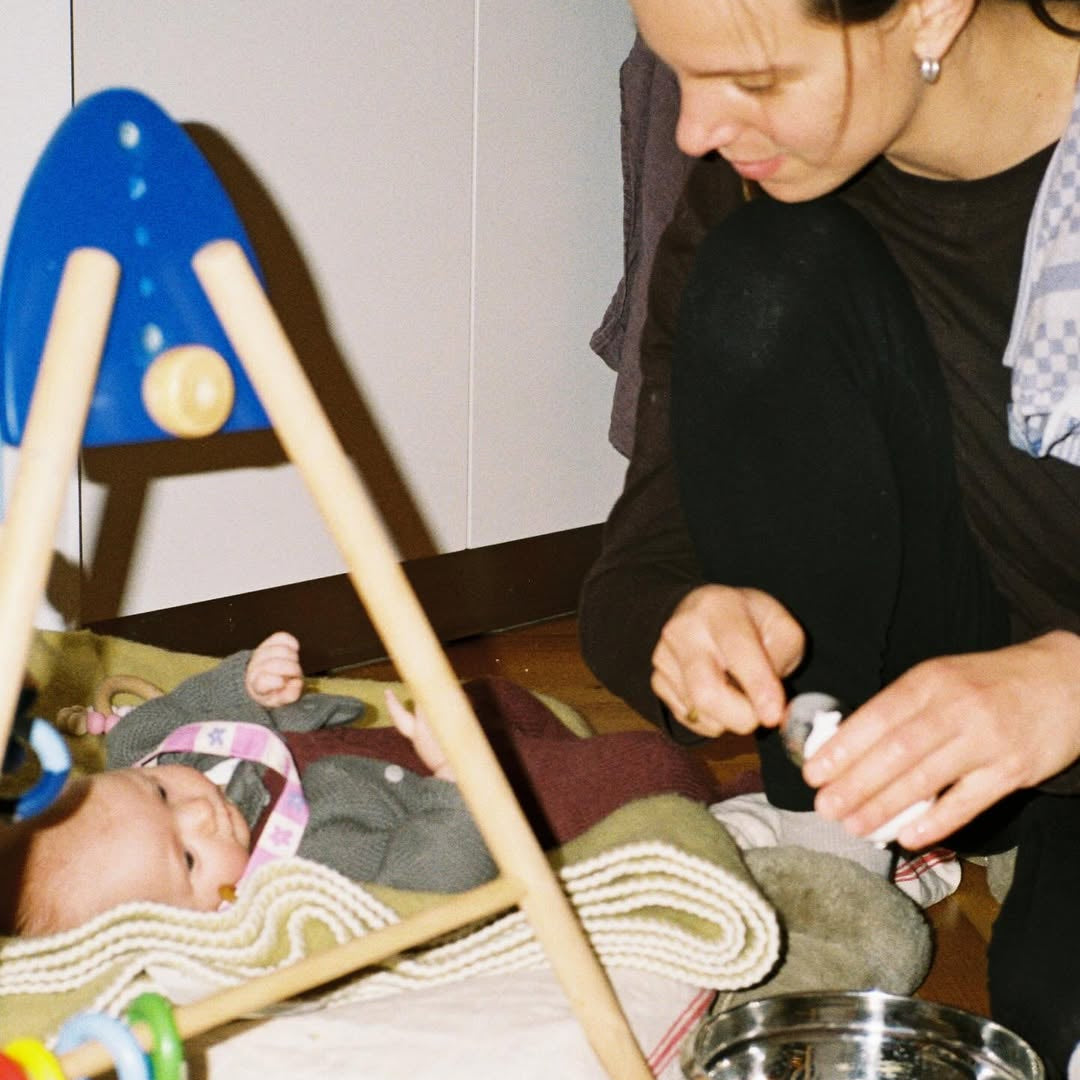 Woman interacting with a baby in a home setting