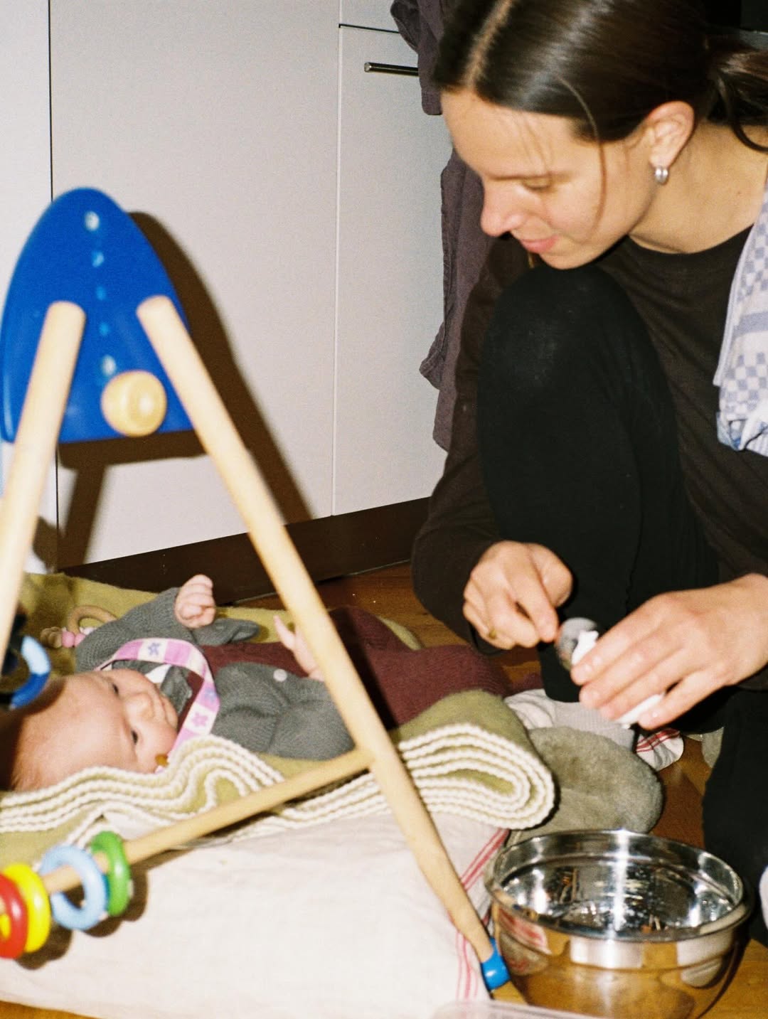 Woman interacting with a baby in a home setting