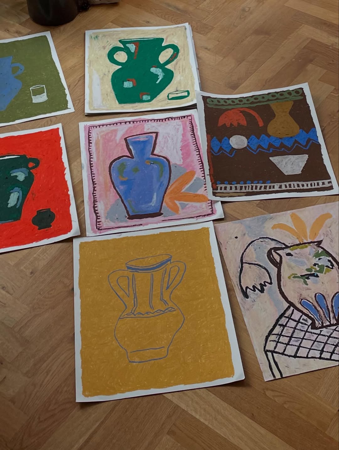 Collection of hand-drawn artwork on paper featuring various vases on a wooden floor.