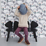 A child sitting on Nofred Black Mouse Bench