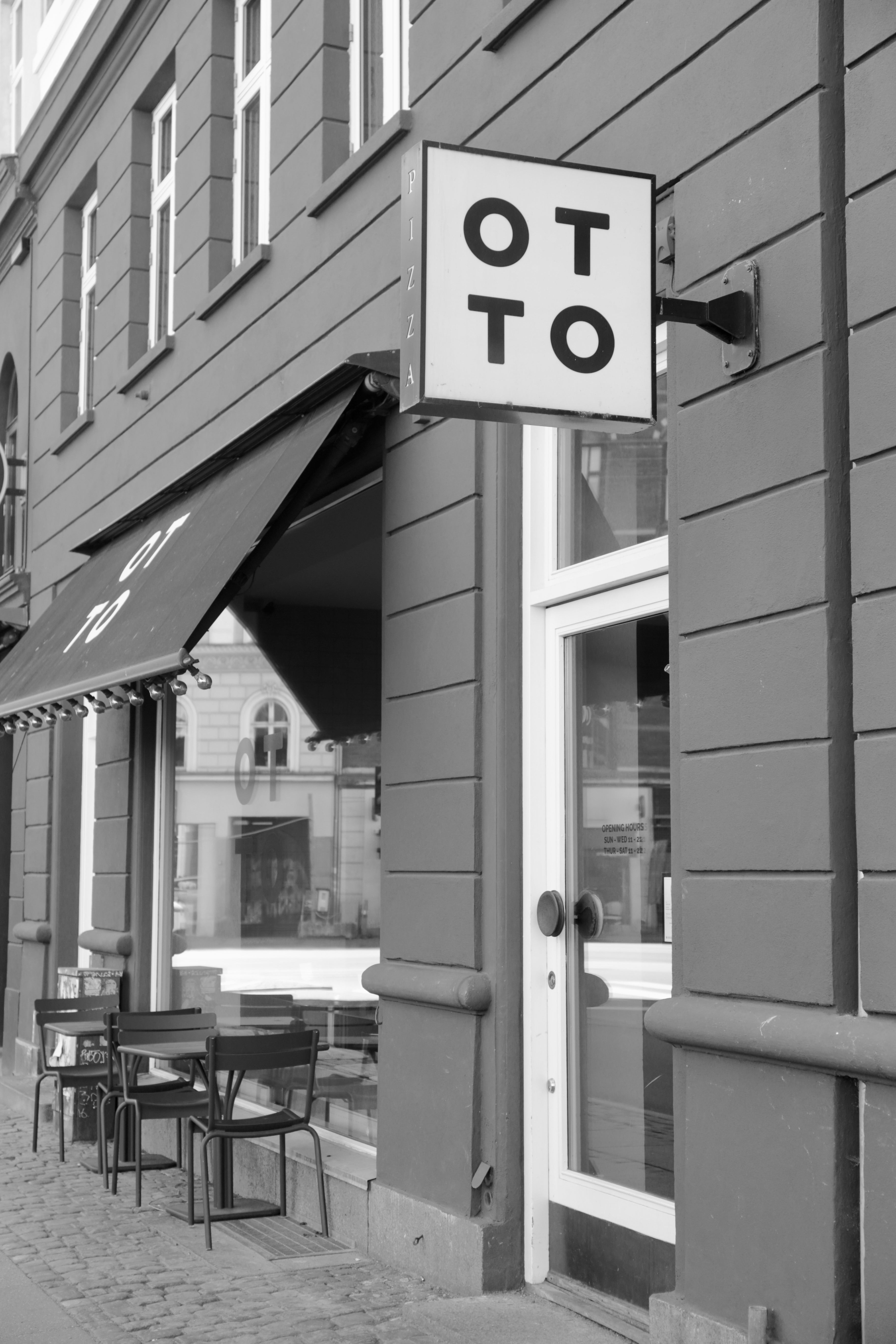 Restaurant exterior with 'OTTO' sign on a building facade