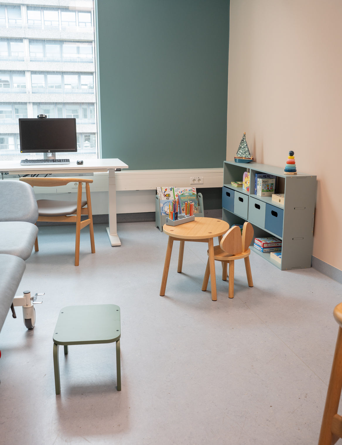 Modern office or study room with desk, chairs, and bookshelves.