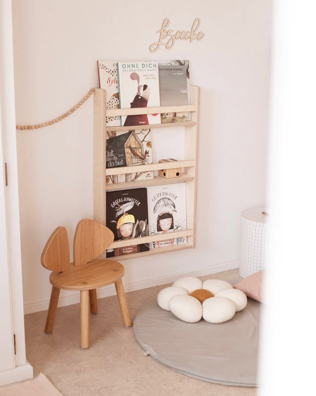 Wooden chair and shelf with books in a cozy room setting